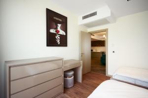 a bedroom with a bed and a dresser in it at Panoramik View Apartment Deluxe Suite in Istanbul