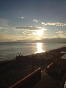 a sunset on the beach with the sun setting at Casa del mare Borgio Verezzi in Borgio Verezzi