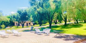 a group of chairs and tables in a park at Green Park Hotel & Residence in Bagnara Calabra