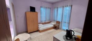 a small room with a bedroom with a bed and a cabinet at Guest House Kukera in Pavel Banya