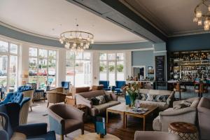 a room with couches and chairs and a bar at Greenbank Hotel in Falmouth