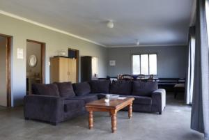 
a living room filled with furniture and a couch at Die Dam Huis in Ashton
