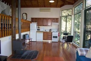a kitchen with wooden cabinets and a stove in a room at Karinya "Peaceful Home" in Bandon Grove