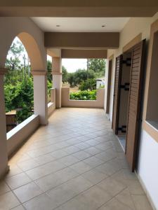 a hallway of a house with a tile floor at 1 Bed Flat - Sleeps 4 - Garden - Parking - Wifi in Mouzákion