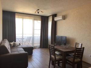 a living room with a couch and a table at Apartment FREEDOM in Shkorpilovtsi
