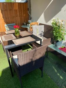 a patio with a table and chairs and a table and a table and chairs at Amber Guest House in London