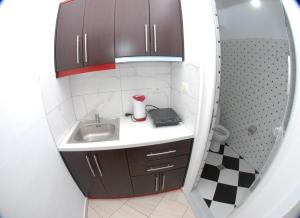 a small bathroom with a sink and a mirror at Vila Enea in Ksamil +71 photos
