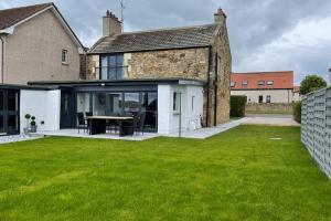 an external view of a house with a green lawn at Castle View House in Dalkeith