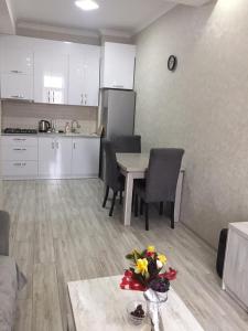 a kitchen and dining room with a table and chairs at 1home in Rustavi