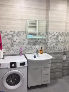 a bathroom with a washing machine and a sink at 1home in Rustavi