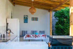 a kitchen with a table and a refrigerator at Athena's Studios in Polychrono