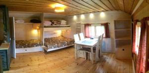 a room with a desk and a table in a tiny house at STF Hotel & Hostel Persåsen in Persåsen +35 photos