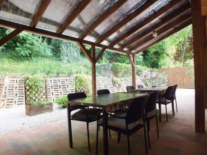 a patio with tables and chairs under a pergola at Arapartman in Zamárdi