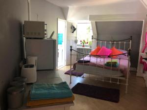 a bedroom with a bed with colorful pillows at Hazelwick in Hookwood