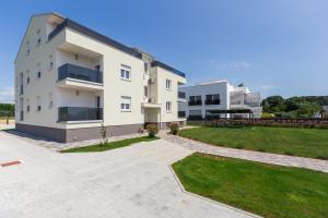 a large white building with a grass yard at Villa Ancora in Rovinj