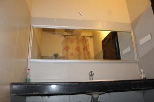 a mirror above a sink in a bathroom at HOTEL STATE RESIDENCY in Bahawalpur +26 photos