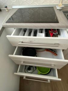 a kitchen drawer filled with lots of tools at Apartma Sinitus in Izola