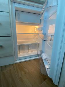 an empty refrigerator with its door open at Apartma Sinitus in Izola