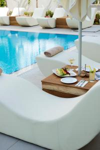 a table with a tray of food next to a pool at Prime Boutique Hotel in Antalya