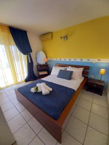 a bedroom with a large bed with two pillows on it at MARIA'S DREAM HOUSE in Eretria