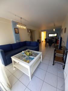 a living room with a blue couch and a table at MARIA'S DREAM HOUSE in Eretria