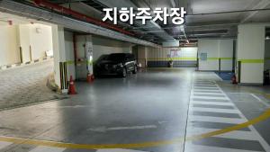 a parking garage with a car parked in it at Geoje Artnouveau Suite Hotel in Geoje 