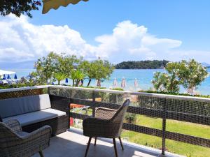a balcony with a view of the water at Two Palm Trees Apartment in Nydri
