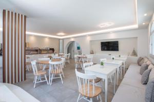 a restaurant with tables and chairs and a couch at Georgia Mare in Naxos Chora