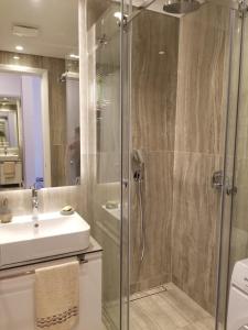 a bathroom with a shower and a sink at Azura Residence - new luxury apartment in Belgrade