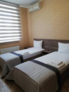 Postel nebo postele na pokoji v ubytování Prometey Hotel