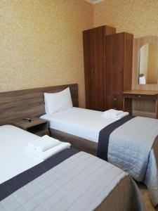 A bed or beds in a room at Prometey Hotel