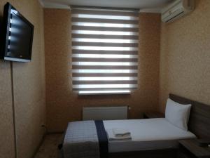 Postel nebo postele na pokoji v ubytování Prometey Hotel