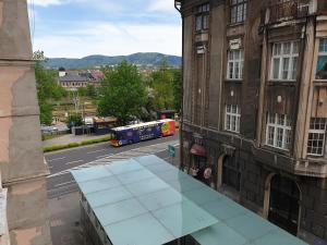 a bus is driving down a city street at Apartament Matejki E in Bielsko-Biala +3 photos
