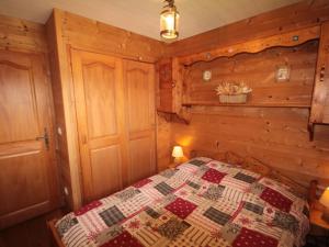 a bedroom with a bed with a quilt on it at Appartement Les Saisies, 3 pièces, 6 personnes - FR-1-293-227 in Les Saisies
