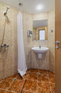 a bathroom with a sink and a shower at Gloria Hotel - All Inclusive in Saints Constantine and Helena