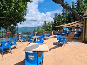 a group of tables and chairs with mountains in the background at Baita Carla in Brunate