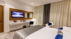 Postel nebo postele na pokoji v ubytování Rose Executive Hotel - DWTC