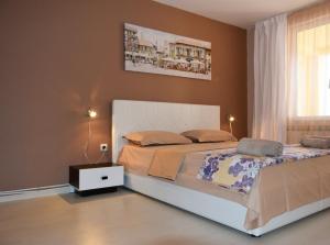 a bedroom with a large bed and a window at dream apartment in Obzor