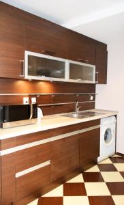 a kitchen with a sink and a microwave at dream apartment in Obzor +14 photos