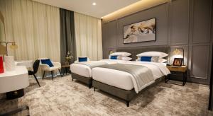 a hotel room with a large bed and a bathroom at Rose Executive Hotel - DWTC in Dubai