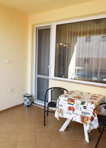 a table and a chair in a room with a window at dream apartment in Obzor