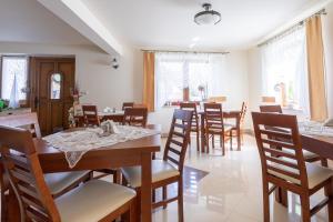 a dining room with wooden tables and chairs at Gościniec Polana Błociska-Na Błociskach in Małe Ciche