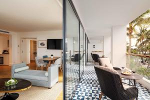 a living room with a table and chairs at Hotel Fariones in Puerto del Carmen