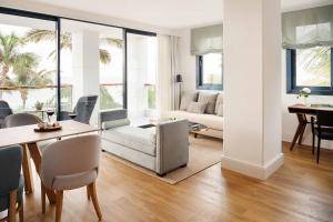 a living room with a couch and a table at Hotel Fariones in Puerto del Carmen