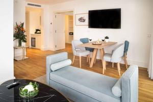 a living room with a blue couch and a table at Hotel Fariones in Puerto del Carmen