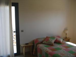 a bedroom with a bed with a quilt on it at Villa Romaní SUITE in Son Carrio