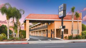 a hotel building with a sign in front of it at Pacific Inn Anaheim in Anaheim