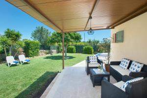 a patio with a wooden pergola at Owl Booking Villa Rafale - 5 Min Drive to The Beach in El Port