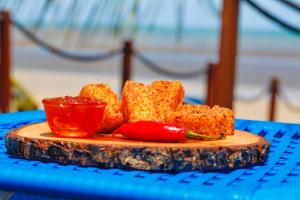 a plate of food on a blue table at Sollaris Ecopousada in Japaratinga