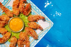 a plate of food with a bowl of dipping sauce at Sollaris Ecopousada in Japaratinga